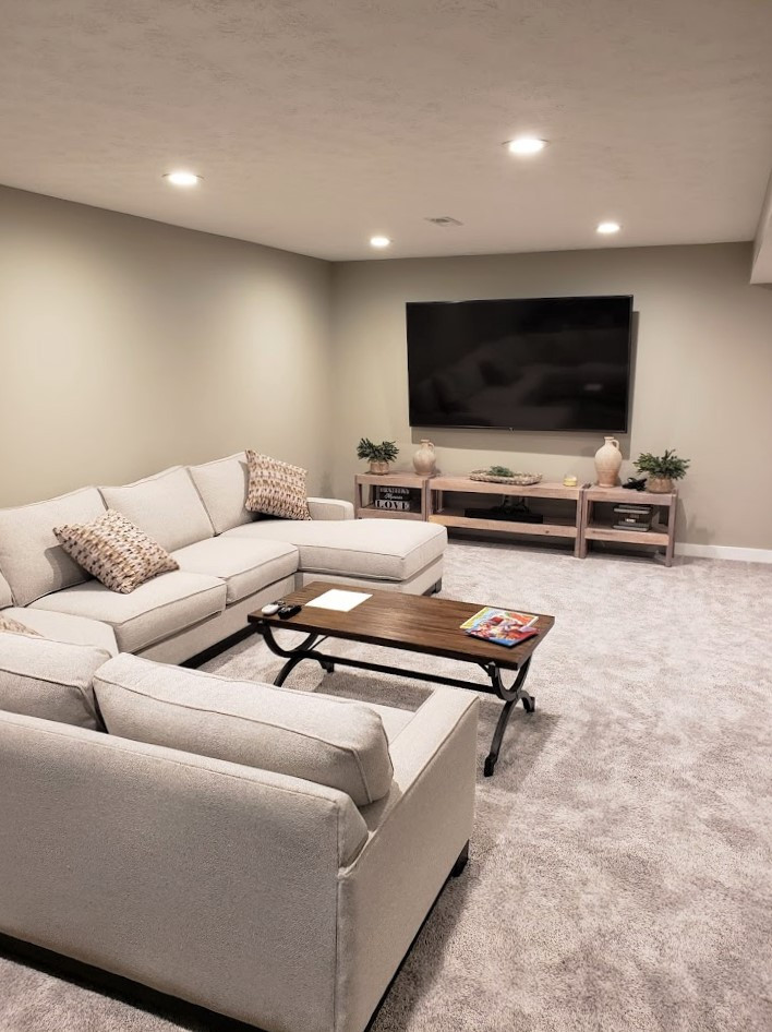 Example of a mid-sized transitional underground carpeted and gray floor basement design in Cleveland with gray walls