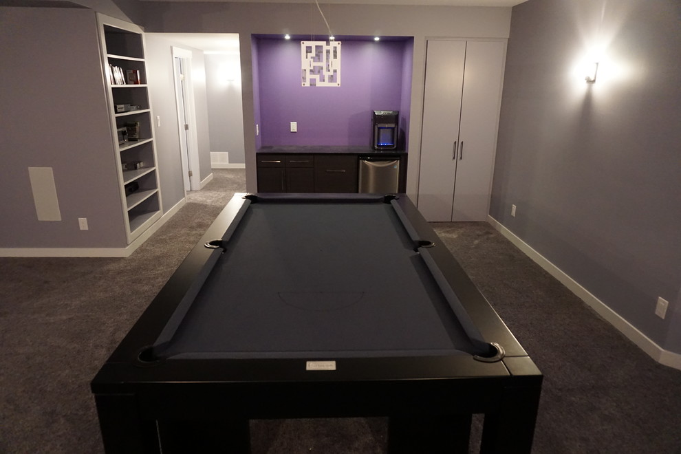 Large modern basement in Calgary with purple walls and carpet.