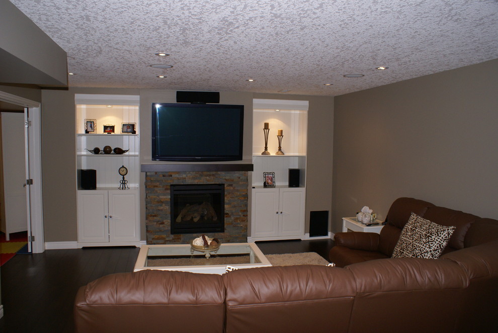 Photo of a traditional basement in Other with beige walls, dark hardwood flooring, a brick fireplace surround and beige floors.