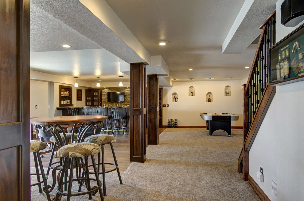 Example of a huge classic look-out carpeted and beige floor basement design in Denver with beige walls and no fireplace