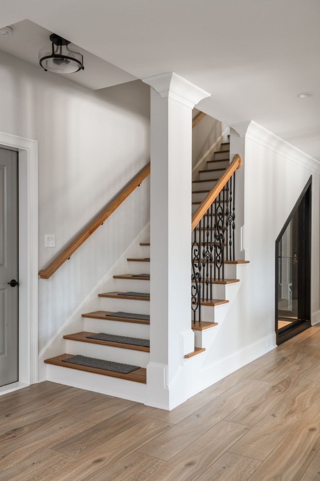 Large coastal staircase in Atlanta with tongue and groove walls.