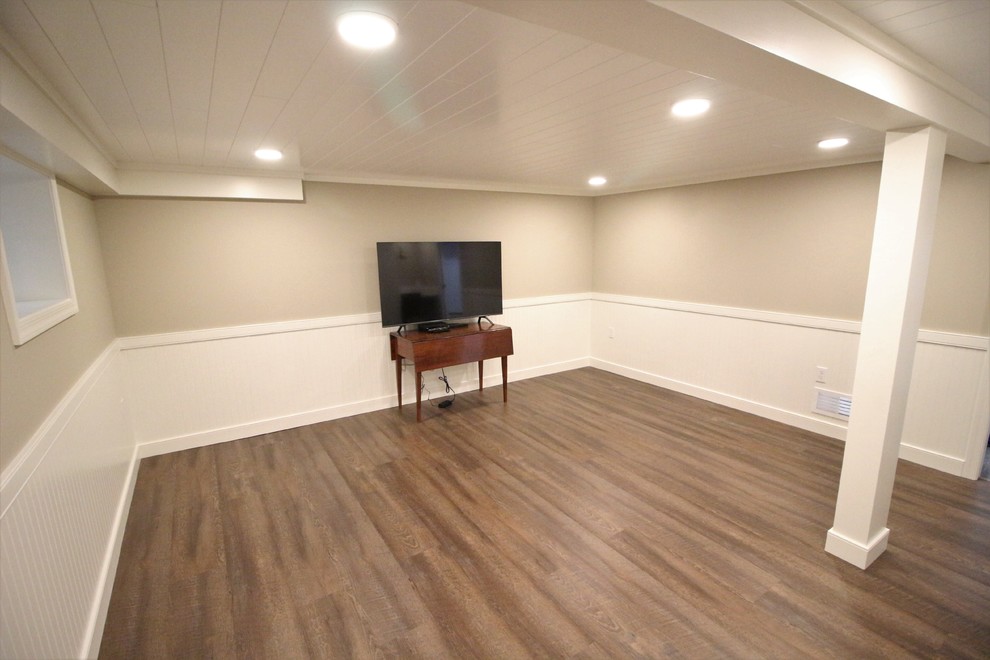 Small traditional fully buried basement in Other with beige walls, cork flooring, no fireplace and brown floors.