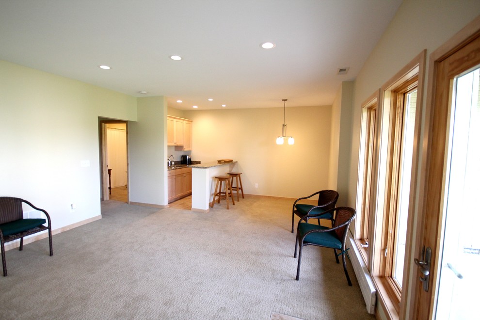 Basement - mid-sized craftsman walk-out carpeted basement idea in Other with white walls and no fireplace