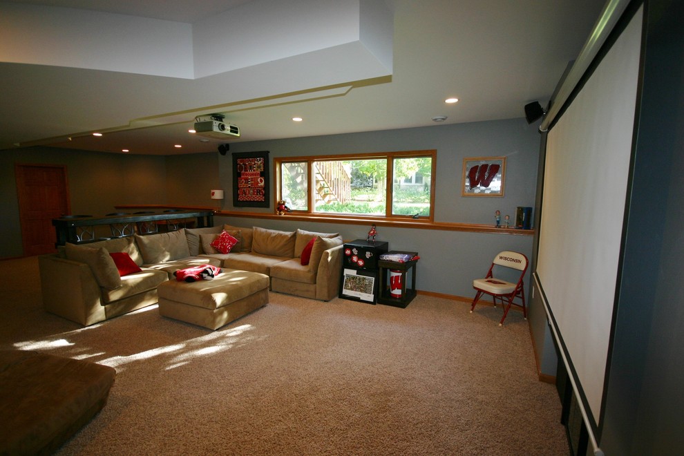 Inspiration for a mid-sized timeless underground carpeted basement remodel in Milwaukee with blue walls and no fireplace