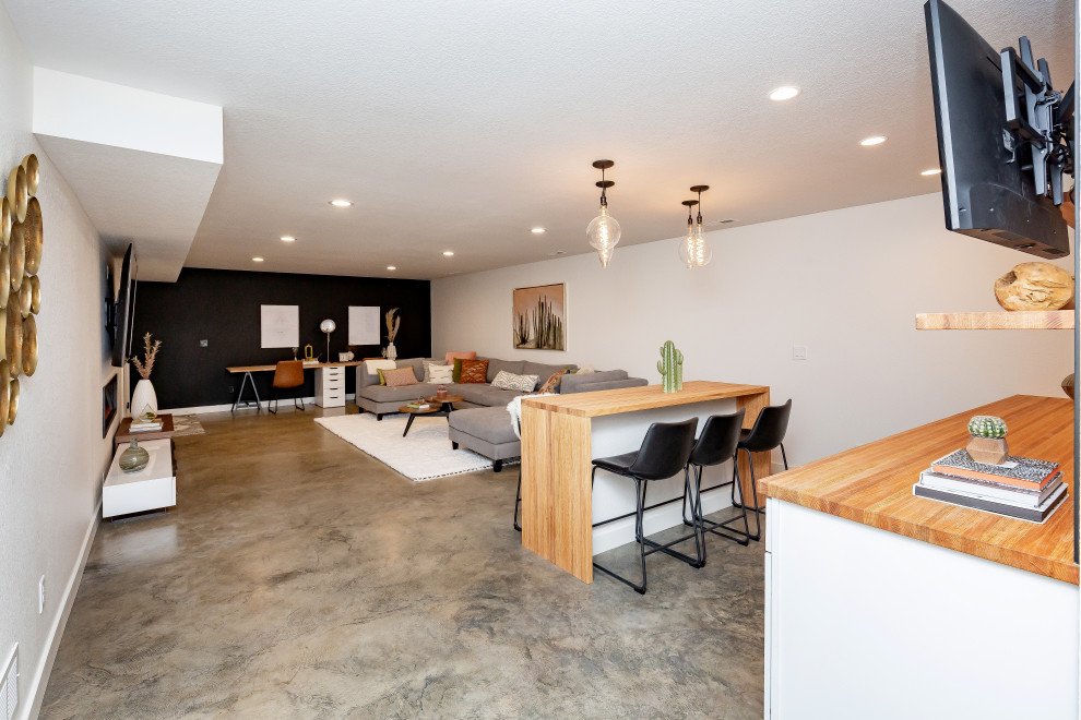 Mid-sized minimalist underground concrete floor basement photo in Other with white walls and a standard fireplace