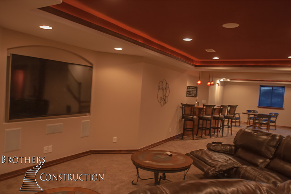 Photo of a medium sized classic fully buried basement in Denver with beige walls, carpet, a standard fireplace and a stone fireplace surround.