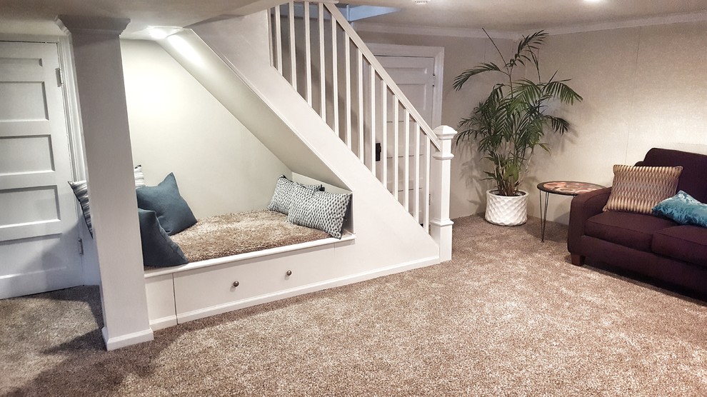 Design ideas for a small traditional walk-out basement in Cincinnati with beige walls, carpet, no fireplace and brown floors.