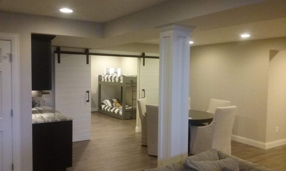 Photo of a large traditional fully buried basement in Columbus with beige walls, vinyl flooring and brown floors.