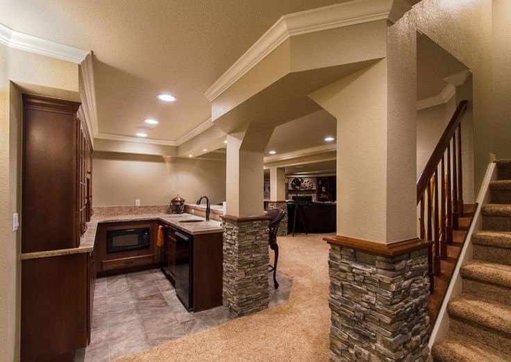 Large elegant underground carpeted and beige floor basement photo in Toronto with beige walls and a standard fireplace