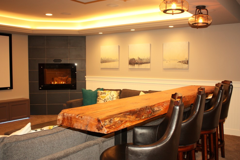 Basement - large transitional underground carpeted basement idea in Vancouver with gray walls, a standard fireplace and a tile fireplace