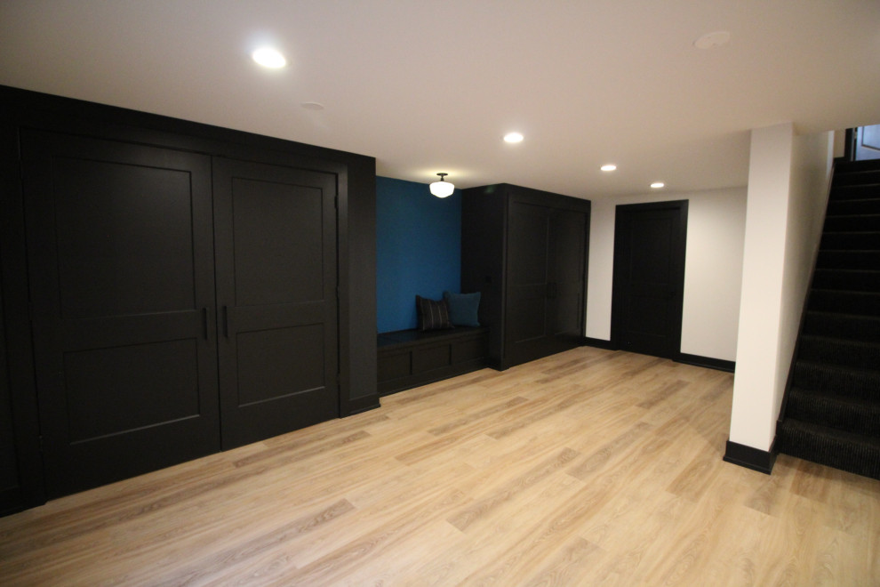 Example of a mid-sized cottage chic multicolored floor basement design in Nashville with white walls