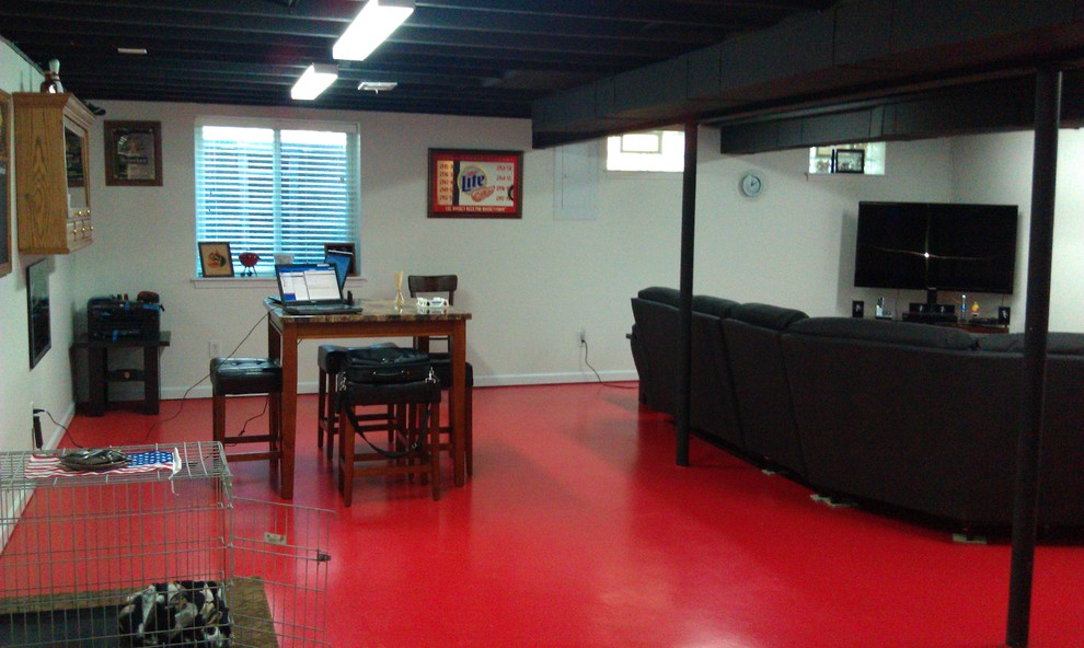 Réalisation d'un sous-sol minimaliste avec un sol rouge.