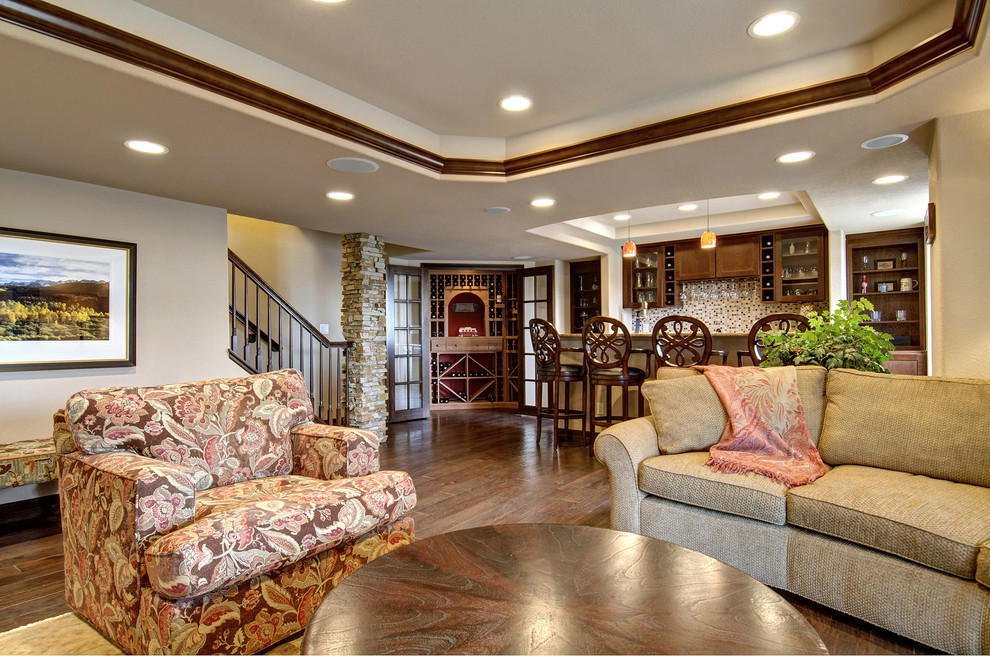 Large elegant look-out medium tone wood floor and brown floor basement photo in Denver with beige walls, a corner fireplace and a stone fireplace