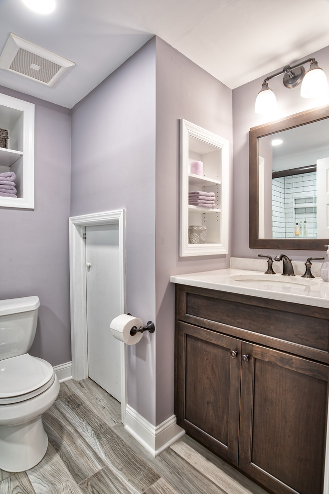 Small cottage underground laminate floor and gray floor basement photo in New York with purple walls