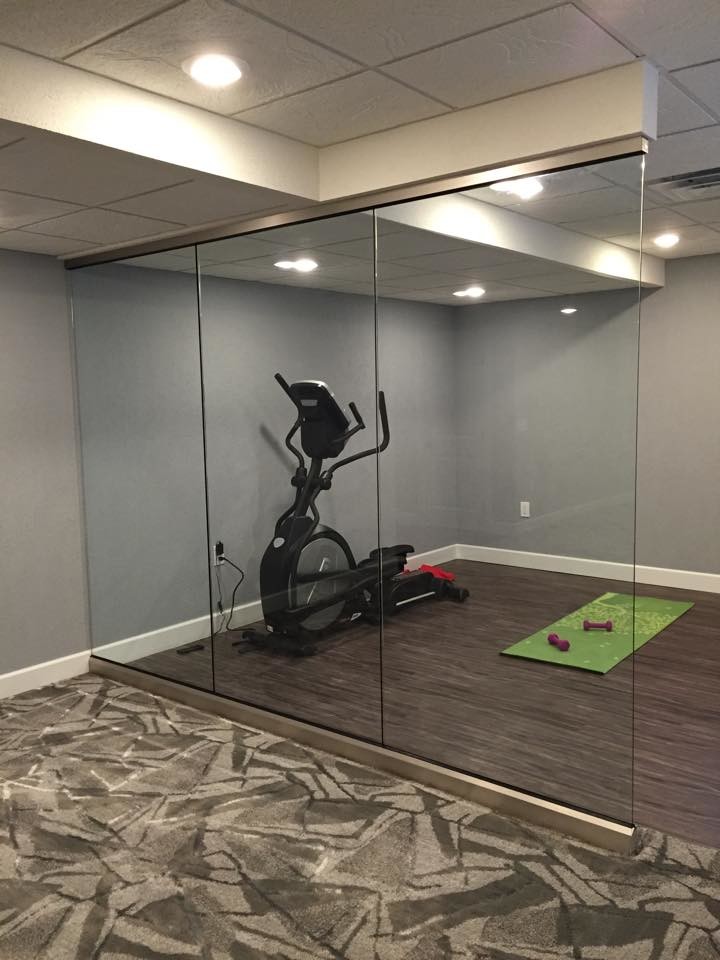Basement gym with luxury vinyl tile - Basement - New York - by Grade A ...