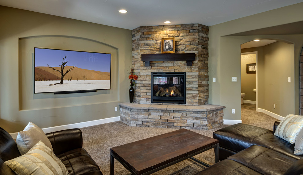 Expansive classic walk-out basement in Denver with beige walls, carpet, a corner fireplace, a stone fireplace surround and brown floors.