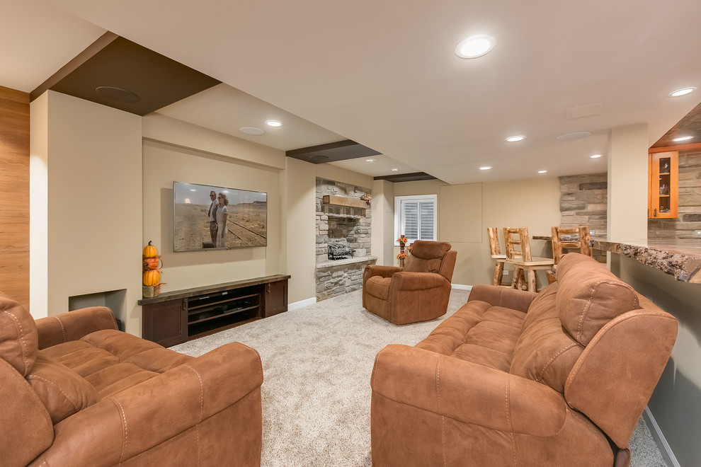 Example of a large mountain style look-out medium tone wood floor and beige floor basement design in Chicago with gray walls, a standard fireplace and a stone fireplace