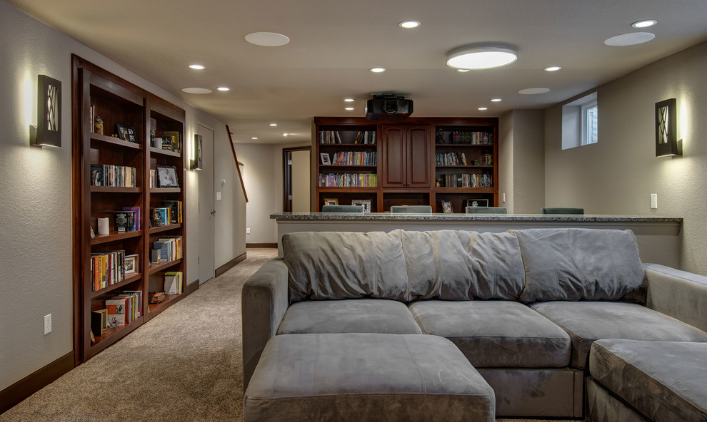 Example of a large transitional look-out carpeted and brown floor basement design in Denver with beige walls, no fireplace and a home theater