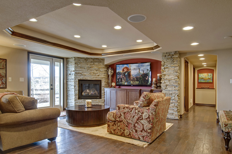 Large elegant look-out medium tone wood floor and brown floor basement photo in Denver with a corner fireplace, beige walls and a stone fireplace