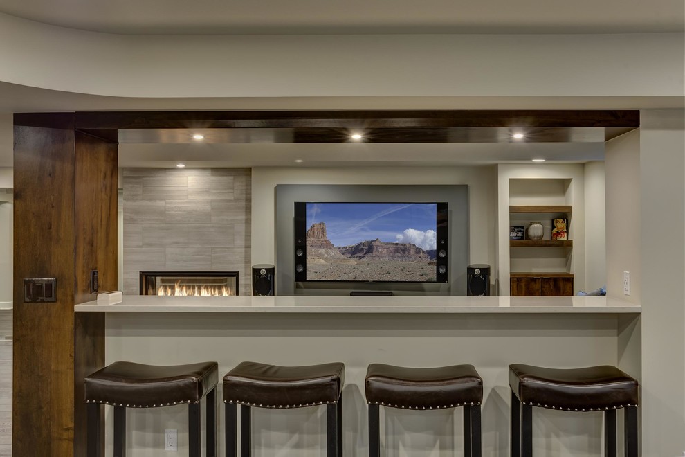 Basement - huge contemporary look-out dark wood floor and brown floor basement idea in Denver with gray walls, a ribbon fireplace and a tile fireplace