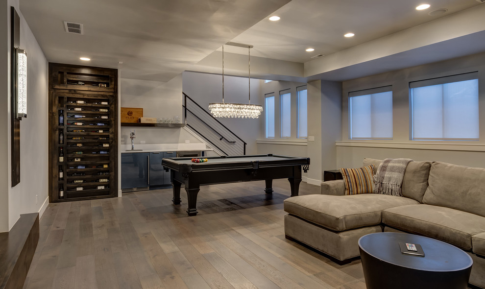 Photo of a large traditional look-out basement in Denver with grey walls, medium hardwood flooring, no fireplace and beige floors.