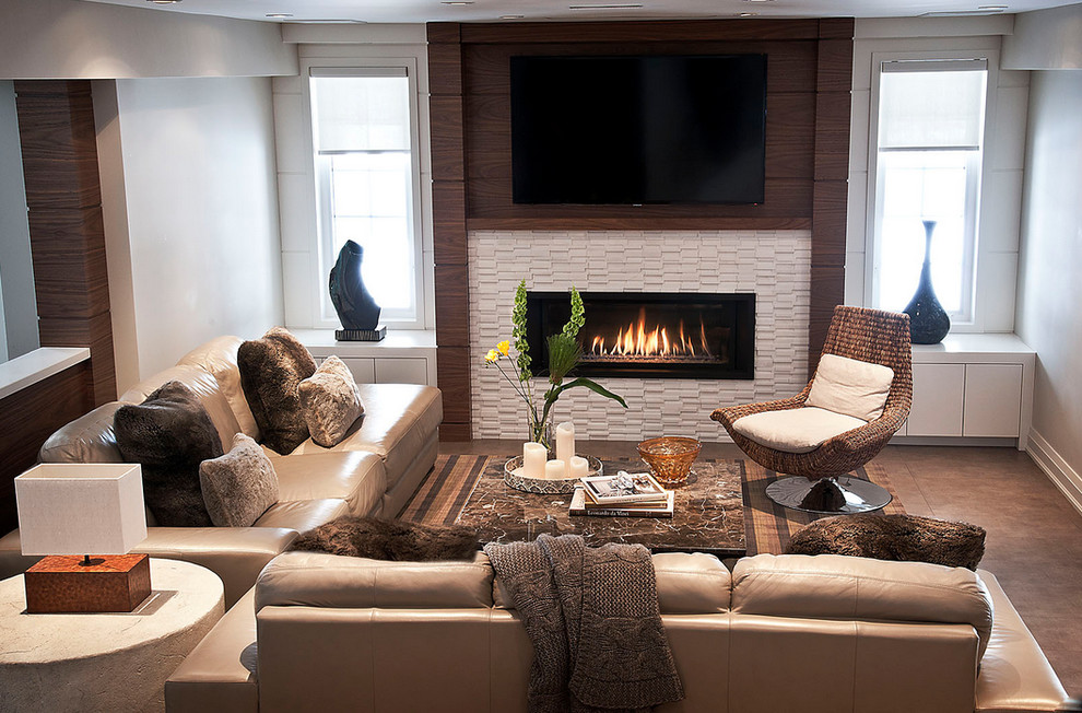 Photo of a contemporary walk-out basement in Toronto with beige walls, porcelain flooring, a ribbon fireplace and a tiled fireplace surround.
