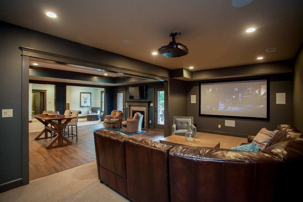 Large mountain style carpeted home theater photo in Orange County with black walls