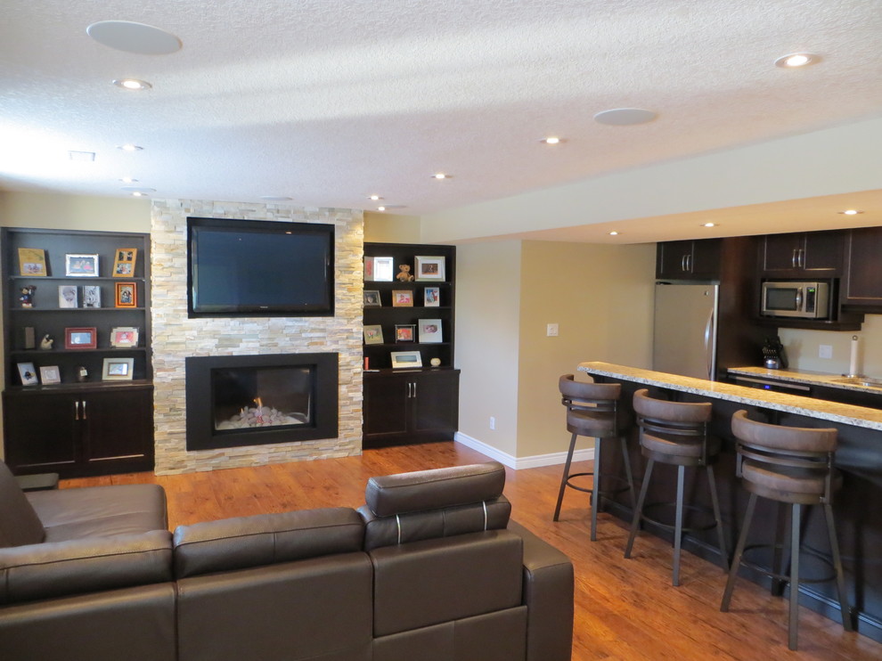 Large transitional look-out medium tone wood floor and brown floor basement photo in Other with beige walls