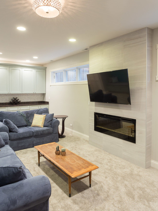 Inspiration for a mid-sized contemporary look-out carpeted basement remodel in Chicago with beige walls and a ribbon fireplace