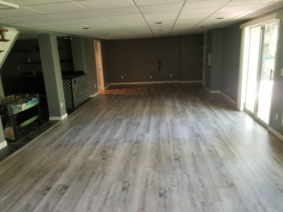 Basement in St Louis with grey walls, vinyl flooring and grey floors.