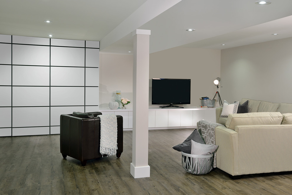 Example of a large minimalist underground basement design in Toronto with gray walls