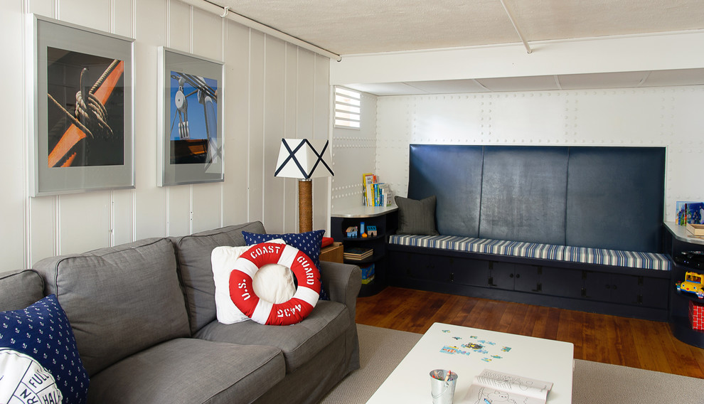 Example of a beach style look-out dark wood floor and brown floor basement design in Boston with white walls and no fireplace