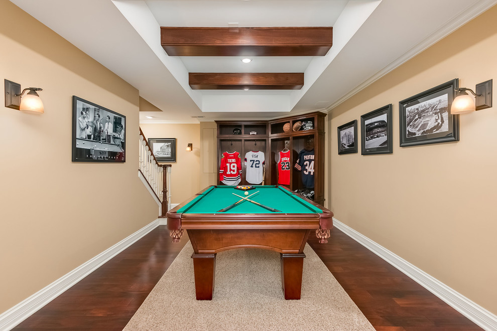 Large traditional walk-out basement in Chicago with beige walls, dark hardwood flooring, a standard fireplace, a stone fireplace surround and brown floors.