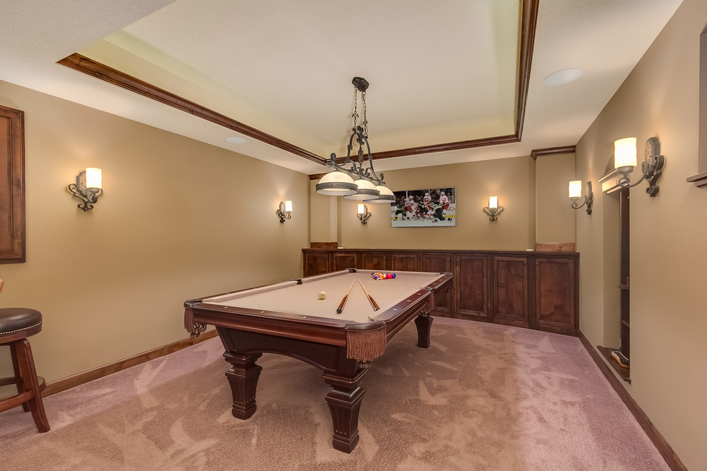 This is an example of a medium sized classic look-out basement in Minneapolis with beige walls, carpet, a standard fireplace, a stone fireplace surround and beige floors.