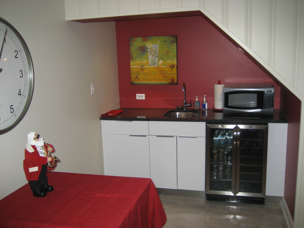Example of a large trendy underground concrete floor and beige floor basement design in Chicago with yellow walls, a corner fireplace and a tile fireplace