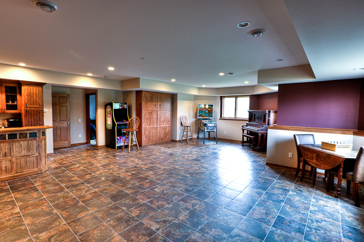 Inspiration for a large timeless ceramic tile family room remodel in Other with beige walls