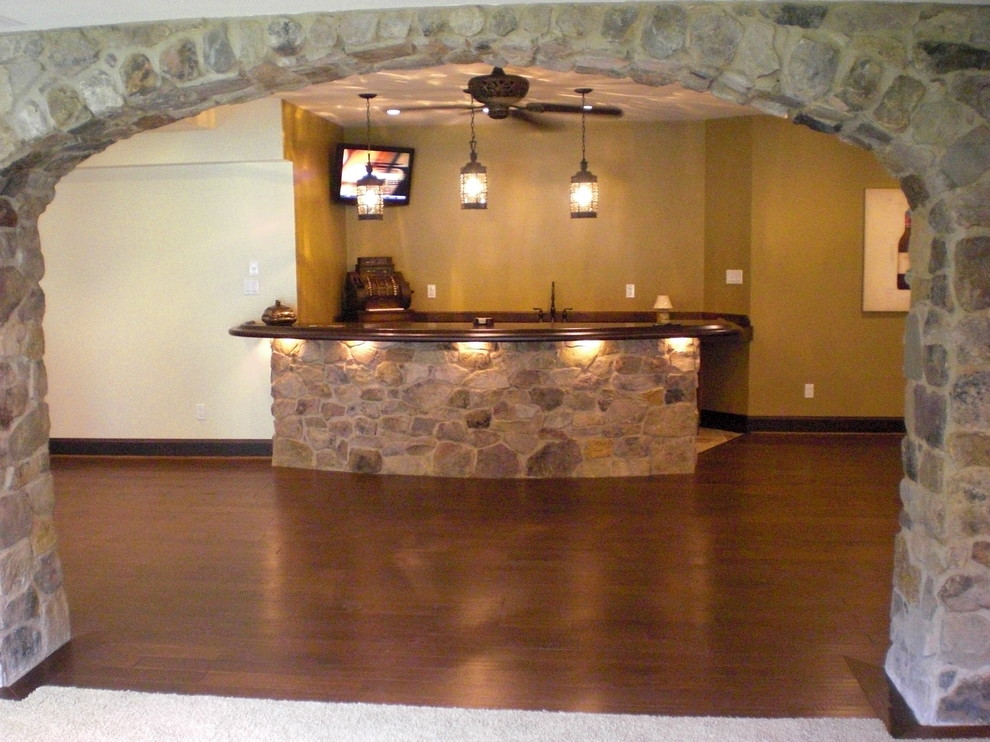 Photo of a large traditional look-out basement in Philadelphia with beige walls, dark hardwood flooring and multi-coloured floors.