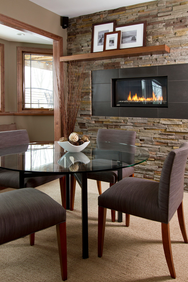This is an example of a contemporary look-out basement in Minneapolis with beige walls, carpet, a ribbon fireplace and beige floors.