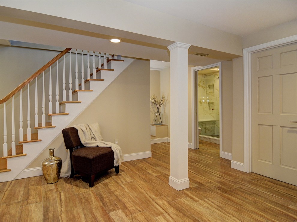Inspiration for a large transitional look-out porcelain tile and brown floor basement game room remodel in Newark with beige walls and no fireplace