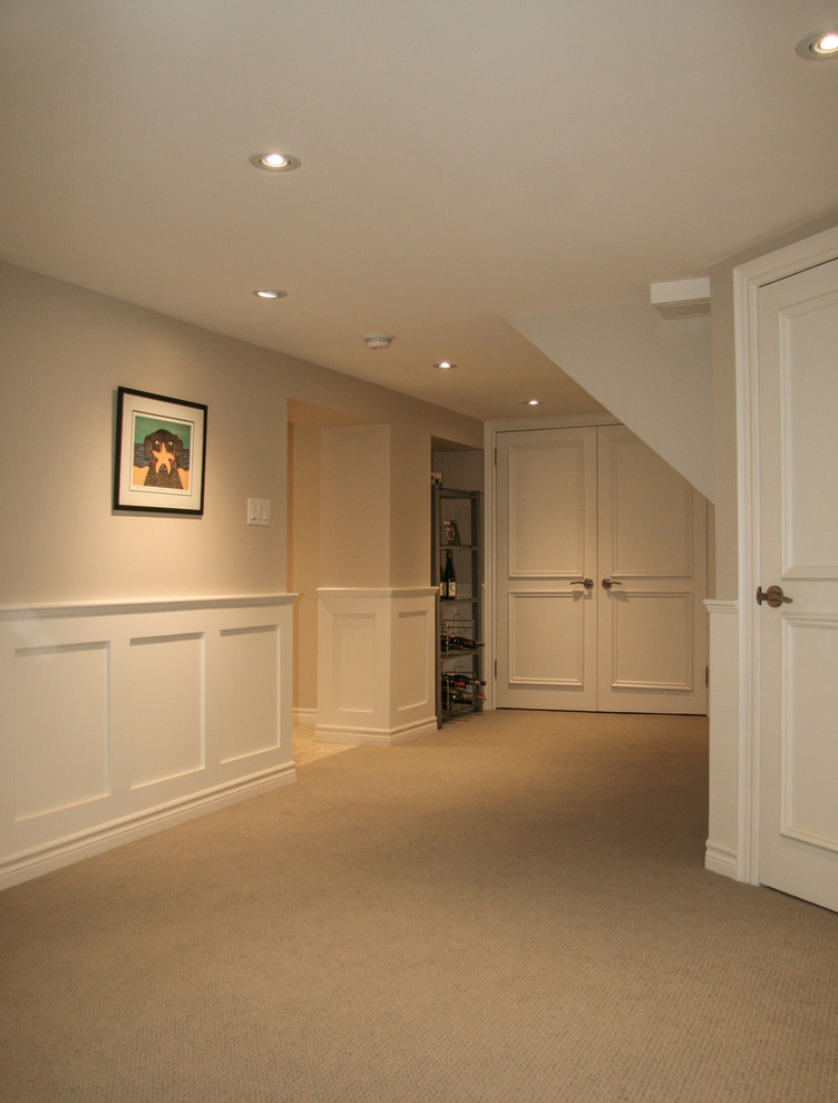Medium sized contemporary walk-out basement in Toronto with beige walls, carpet and beige floors.