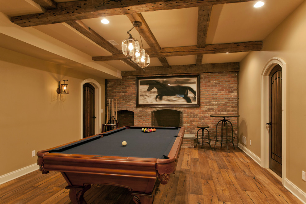 Inspiration for a large rustic underground medium tone wood floor basement remodel in New York with beige walls, a standard fireplace and a brick fireplace