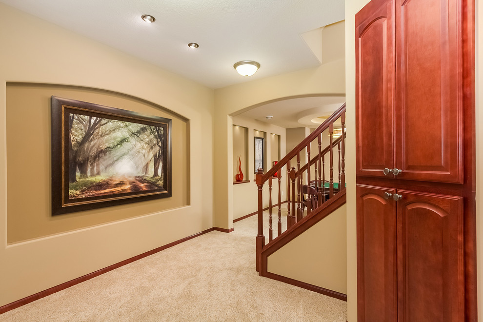 Medium sized traditional fully buried basement in Minneapolis with beige walls, carpet, no fireplace and grey floors.