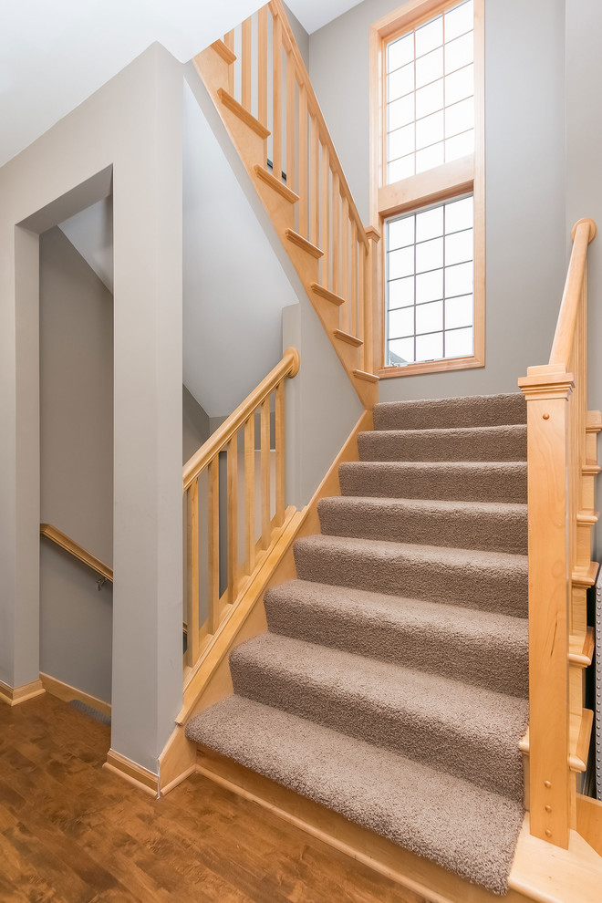 Example of a large transitional staircase design in Minneapolis