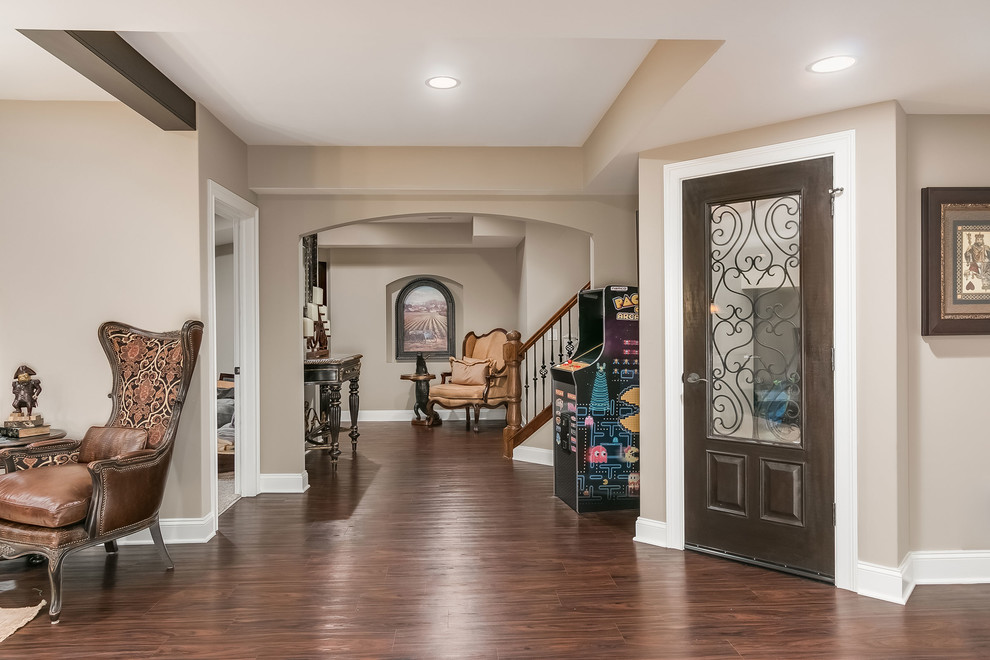 Photo of an expansive traditional look-out basement in Chicago with grey walls, dark hardwood flooring, a corner fireplace, a brick fireplace surround and brown floors.