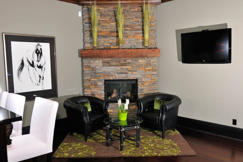 This is an example of a contemporary basement in Vancouver with a corner fireplace.
