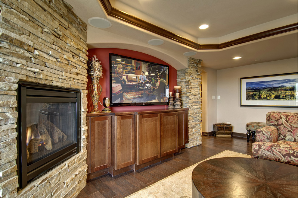 Example of a large classic look-out medium tone wood floor and brown floor basement design in Denver with beige walls, a corner fireplace and a stone fireplace