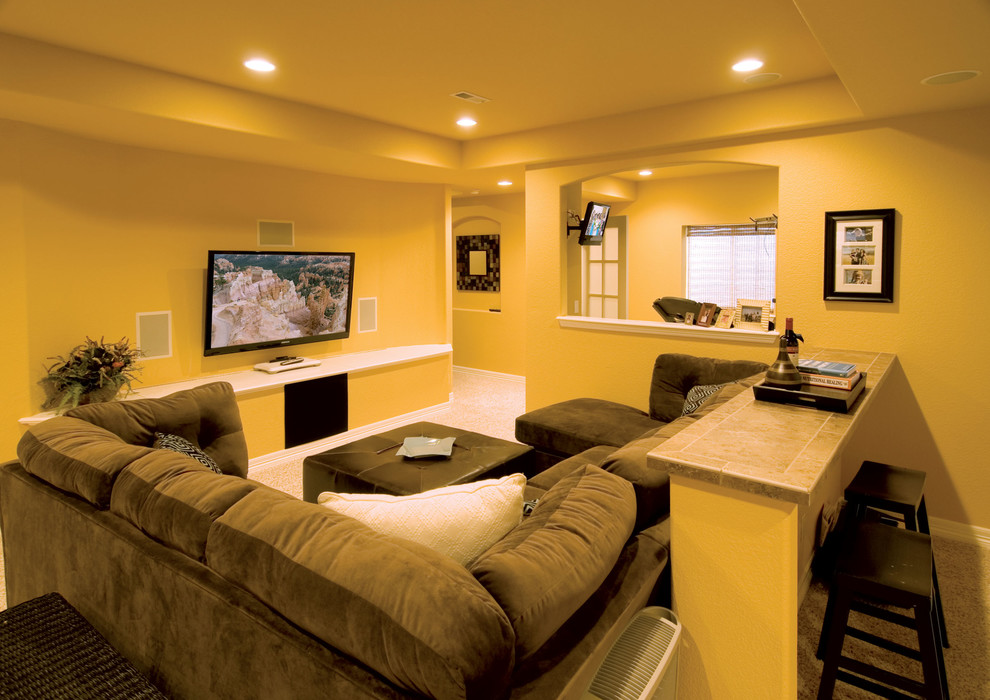 Inspiration for a large traditional look-out basement in Denver with yellow walls, carpet, no fireplace and beige floors.