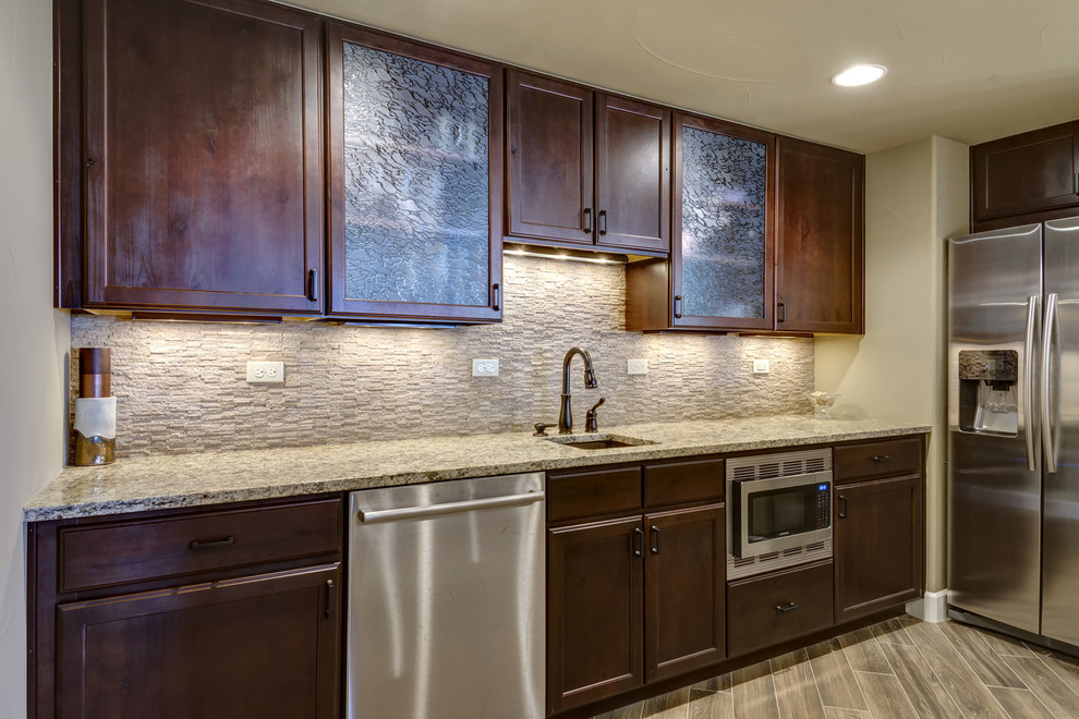 Basement - huge transitional walk-out vinyl floor and brown floor basement idea in Denver with beige walls, a corner fireplace and a stone fireplace