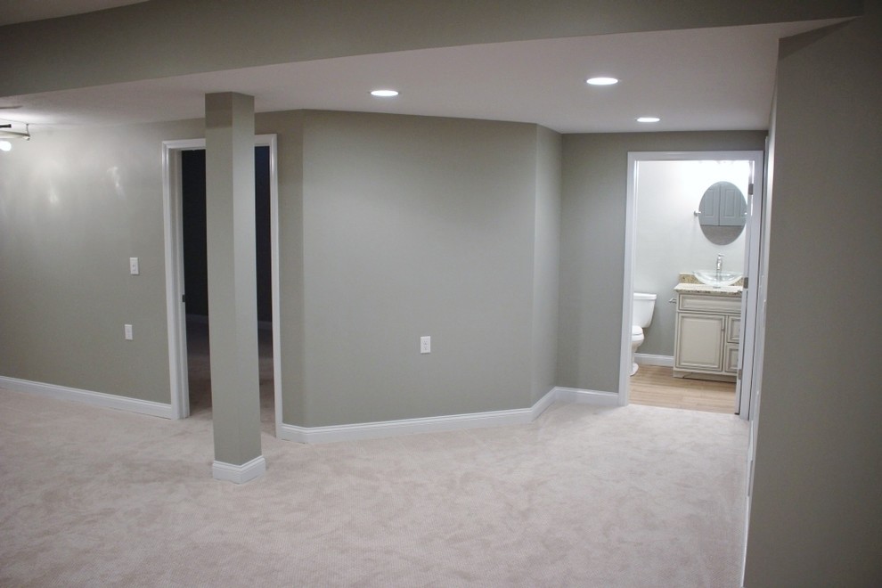 Photo of a large traditional fully buried basement in Cleveland with green walls and carpet.
