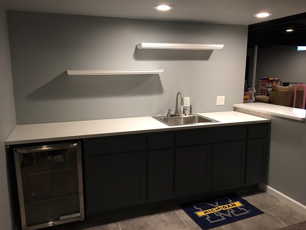 Modern basement in Detroit with grey walls and ceramic flooring.